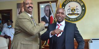 Acting Nairobi Governor Benson Mutura is congratulated by NMS Director Mohamed Badi