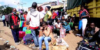 People wait to travel to western Kenya from Machakos Country Bus Station in Nairobi on December 20, 2020.