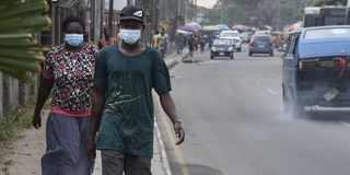 People walk along a main road in Lagos, Nigeria in 2020.