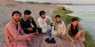 Men smoke shisha