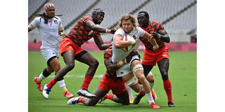USA's Joe Schroeder (second right) tries to break through Kenya's defence