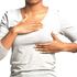 A woman examining her breast.