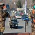 Taliban fighters stand guard