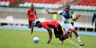 KCB midfielder Samuel Mwangi vies with AFC Leopards striker Victor Omune