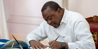 President Uhuru Kenyatta signing parliamentary Bills