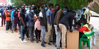 Members of the public queue to register as voters in Eldoret.