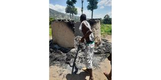 Man stares at the shell of his house in Kapsiren village, Marakwet East sub-county. Police burnt down houses in an operation.