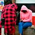 Residents sit at a corner all covered up to keep warm 