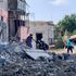 People evacuating from a destroyed residential building after shelling in the town of Voznesensk.