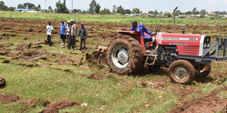 Residents of Njambini-Yamumbi in Eldoret, Uasin Gishu County look on as a tractor ploughs the killer Njambini playground