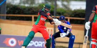 Kenya's batsman Irfan Karim (left) bats under pressure from Nepal's Wicketkeeper Aarif Sheikh