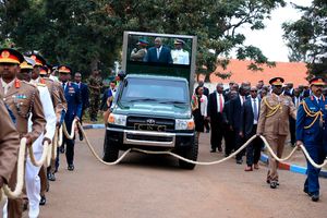 President Uhuru Kenyatta is pulled by high-ranking military officers.
