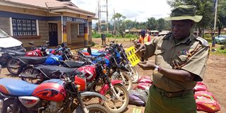 Endebess OCPD Mr Salesio Murrithi verifying a number plate from a stolen motorcycle at Endebess police station