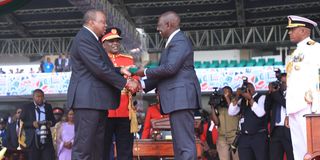 President William Ruto when being handed the instruments of power by former President Uhuru Kenyatta.
