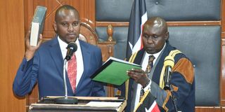 Philip Kipng'etich Muigei (left), is sworn-in as a Speaker of Uasin Gishu County Assembly by assembly Clerk Shadrack Choge
