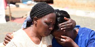 Ruth Njoroge (right) the elder sister of lawyer Paul Gicheru is consoled by a relative Mary Wanjiku.
