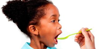 A child taking syrup.