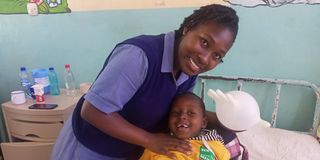 Elizabeth Robai Lukresia, a second year pediatric student nurse at Kenya Medical Training College (KMTC) with a child patient