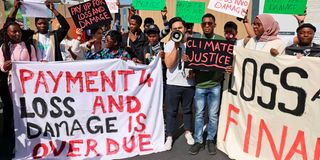 Demonstrators hold a protest outside the venue hosting the COP27 climate conference