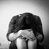 sad woman head on knees