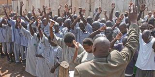 A religious leader conducts a service for inmates at Kodiaga prison in Kisumu County