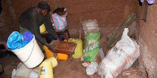 Celine Adhiambo Otieno arranging her household items in Kibera
