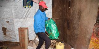 Peter Okumu arranging his household items in Kibera
