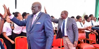 President William Ruto (right) and former Education CS George Magoha