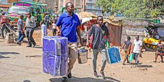 Parents and guardians and their children were busy doing last-minute shopping in Gikomba, Nairobi