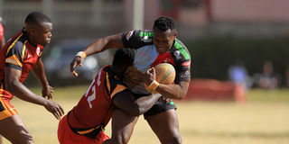 Paul Mutsami (right) of Kenya Harlequin vies with David Ochieng of Blak Blad
