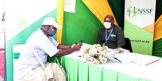 An NSSF official talks to a client at the Kenyatta International Convention Centre