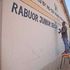 A worker puts the final touches on a classroom at Rabuor Junior Secondary School 