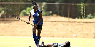 Grace Bwire (down) of Strathmore University Scorpions in action against Alice Owiti of Lakers