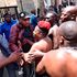 Comedian Eric Omondi (right) struggles with police officers in an attempt to force his way into Parliament Buildings in Nairobi