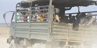 A police vehicle carries mourners to the burial of a bandit attack victim in Kapedo on the border of Turkana and Baringo