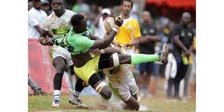 Kabras RFC's Lameck Ambetsa is tackled by KCB's Jacob Ojee and Peter Kilonzo