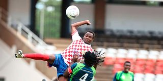 Nzoia Sugar midfielder Hassan Beja (left) vies for the ball with KCB midfielder Michael Mutinda