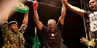 Kenya's Rayton Okwiri (centre) celebrates after winning his middleweight non-title bout