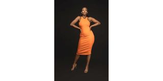 Cyanne Aduda in an Orange ribbed dress.