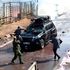 A man lobes a teargas canister into an empty vehicle that was part of the opposition leader Raila Odinga's entourage 