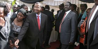 Former Prime Minister Raila Odinga (right) and former IEBC chairman Issack Hassan in Kibera