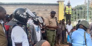 Police at the scene where a mob lynched and burnt a suspected thug in Makutano, West Pokot county on April 12, 2023.
