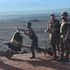 A Congolese man pushes a cart past  KDF soldiers