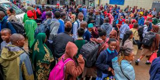 Travellers among them students wait to board Matatus at Afya Centre, Nairobi County