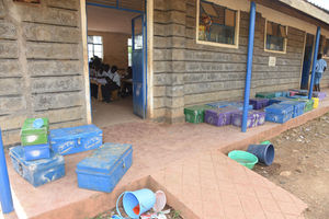 Learning going on at Kapindasum Primary Schools in Baringo South, with learners' metal boxes outside