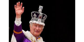 Britain's King Charles III wearing the Imperial State Crown, waves from the Buckingham Palace balcony