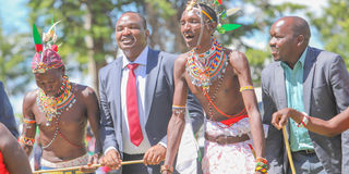 Baringo County Deputy Governor Felix Maiyo and Bartabwa MCA David Sitoi having a jig with Loropil traditional dancers