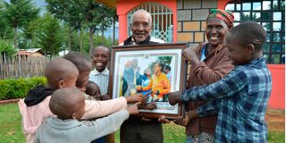 Faith Kipyegon's father Samuel Kipyegon Koech (left) and her mother Jane Chepkosgei and their grandchildren