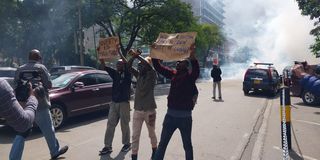 Anti-Finance Bill 2023 protesters hold placards in Nairobi city centre