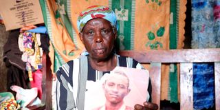 Burnice Kagori Maina holds a photo of her son Saidi Ndung’u who was reportedly killed by Del Monte guards.
